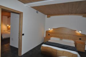 Postel nebo postele na pokoji v ubytování Albergo Alpino