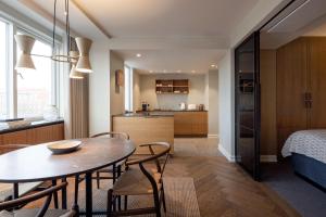 a kitchen and dining room with a table and chairs at Hypernym Hotel & Suites in Copenhagen