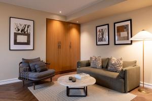 a living room with a couch and a table at Hypernym Hotel & Suites in Copenhagen