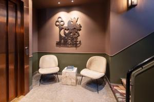 two chairs and a table in a waiting room at Hypernym Hotel & Suites in Copenhagen