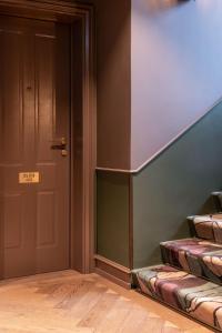 an empty room with a door and a stair case at Hypernym Hotel & Suites in Copenhagen