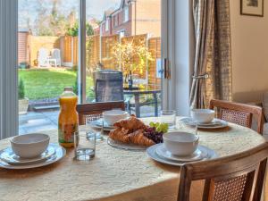 a table with food and drinks on it with a window at Lovely Detached Home Pass The Keys in Telford
