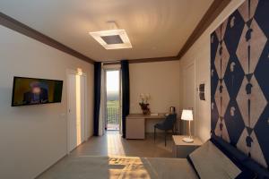 a living room with a couch and a table and a window at La Villa in Novara