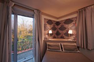 a bedroom with a bed and a large window at La Villa in Novara