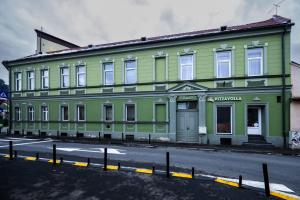 a green building on the side of a street at Casa Basarab Brasov in Braşov