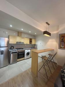a kitchen with stainless steel appliances and a table at Holikeys - Rabat - 1 Ch - Agdal 002 in Rabat