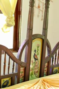 a wooden chair with a picture of a bird on it at Embe Lodge in Kizimkazi