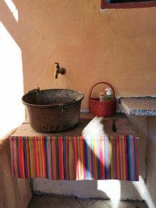 an old tub sitting on a table in a bathroom at Adagio Guesthouse in Caprie