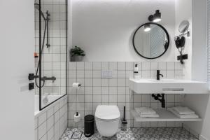 a bathroom with a sink and a toilet and a mirror at Konventa Sēta Hotel Keystone Collection in Rīga
