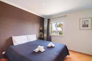 ein Schlafzimmer mit einem Bett mit zwei Handtüchern darauf in der Unterkunft Estrela do mar in Santa Luzia