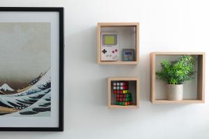 a wall with two picture frames and a plant on it at Princes Street in the Heart of Bath in Bath