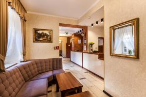 uma sala de estar com um sofá e uma mesa em Hotel Maksymilian em Cracóvia