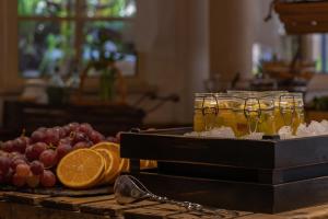 a tray of food with fruit on a table at Charming Residence & Guest House Dom Manuel I Adults only in Lagos