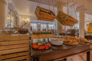 a buffet with different types of food on a table at Charming Residence & Guest House Dom Manuel I Adults only in Lagos