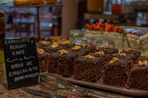 a display of chocolate peanut cake on a table at Charming Residence & Guest House Dom Manuel I Adults only in Lagos