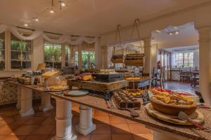 a kitchen with a buffet of food on a table at Charming Residence & Guest House Dom Manuel I Adults only in Lagos