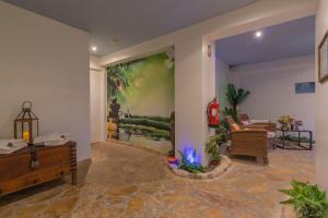 a living room with a large painting on the wall at Charming Residence & Guest House Dom Manuel I Adults only in Lagos