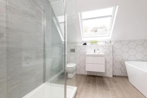 a bathroom with a shower and a toilet and a sink at Stunning Dalchenna w/hot tub & huge garden in Stirling