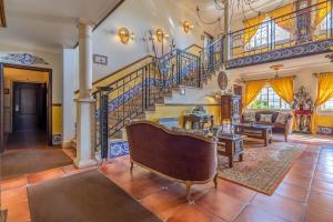 a living room with a staircase and a couch at Charming Residence & Guest House Dom Manuel I Adults only in Lagos