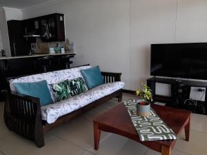 a living room with a couch and a coffee table at CoRAL REEF 207 in La Mercy