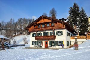 a large house in the snow with snow at Appartementhaus Bad Salve in Hopfgarten im Brixental