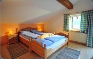 a bedroom with two twin beds and a window at Appartementhaus Bad Salve in Hopfgarten im Brixental