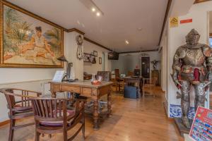 a room with a table and a statue of a man at Charming Residence & Guest House Dom Manuel I Adults only in Lagos