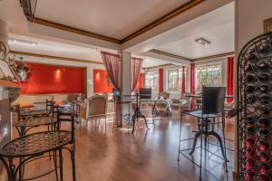 a room with chairs and tables and red walls at Charming Residence & Guest House Dom Manuel I Adults only in Lagos