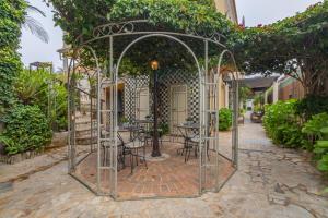 a metal gazebo with tables and chairs in it at Charming Residence & Guest House Dom Manuel I Adults only in Lagos