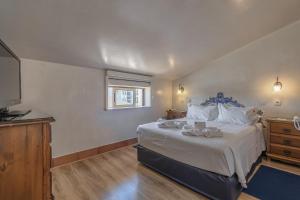 a bedroom with a large bed and a television at Charming Residence & Guest House Dom Manuel I Adults only in Lagos