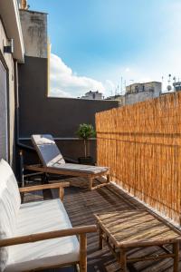 a patio with a table and chairs on a balcony at Cosy and stylish apartment in the centre in Athens