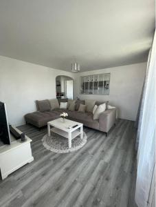 uma sala de estar com um sofá e uma mesa em Appartement proche aéroport em Marignane