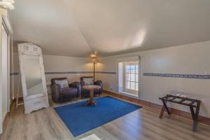 a living room with a chair and a blue rug at Charming Residence & Guest House Dom Manuel I Adults only in Lagos