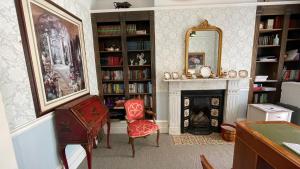 a living room with a fireplace and a mirror at Yorke Lodge Bed and Breakfast in Canterbury