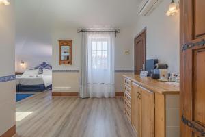 a room with a kitchen and a bedroom with a bed at Charming Residence & Guest House Dom Manuel I Adults only in Lagos