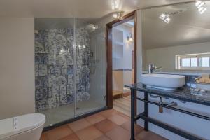 a bathroom with a sink and a shower at Charming Residence & Guest House Dom Manuel I Adults only in Lagos