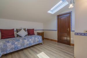 a bedroom with a bed and a brown door at Charming Residence & Guest House Dom Manuel I Adults only in Lagos