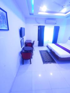 a bedroom with a bed and a desk and a chair at Mj birla international in Hyderabad