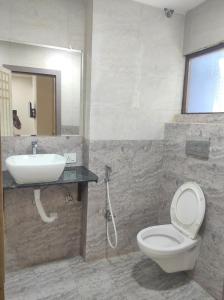 a bathroom with a toilet and a sink at Mj birla international in Hyderabad
