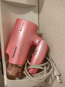 a pink appliance in a box with a cord at 佐世保　貸切小さな一軒家　GUEST HOUSE　楽楽 Luck-Luck in Sasebo