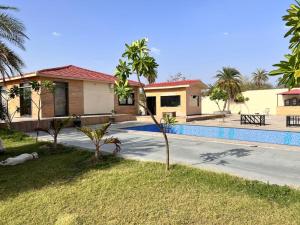 a house with a swimming pool in front of it at Kadwali Villa with Private Pool in Ujjain