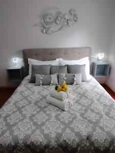 a bedroom with a large bed with towels on it at Volos Hospitality, Central Apartment in Volos