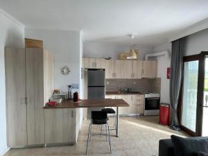 a kitchen with wooden cabinets and a wooden counter top at V&Z Apartment Seaview in Ofrínion +20 photos