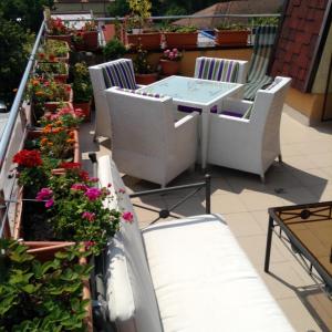 a balcony with a table and chairs and flowers at Penthouse City Centre in Iaşi