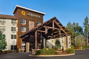 a building with a sunmill sign on the front of it at La Quinta Inn & Suites by Wyndham Lake George in Lake George