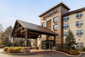 a rendering of a hotel with a building at La Quinta Inn & Suites by Wyndham Lake George in Lake George