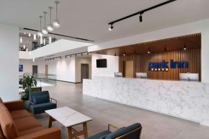 a lobby with a waiting area with chairs and a bar at Park Inn by Radisson Makkah Thakher Alsharqi in Makkah