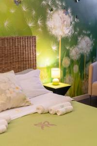 a bedroom with a bed with dandelions on the wall at GREEN butterfly house holiday in Rome