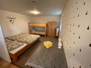 a small bedroom with a bunk bed and a wall at Chata Trojanovice in Trojanovice +55 photos