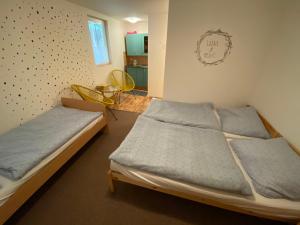 a bedroom with two beds and a table in it at Chata Trojanovice in Trojanovice